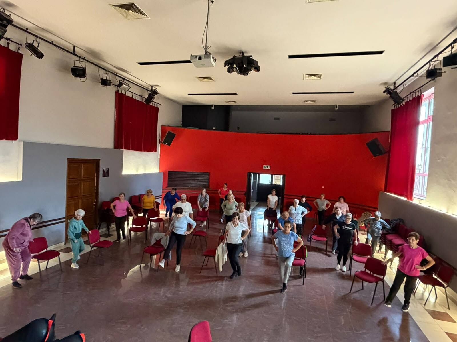 Large group exercising together in a community hall